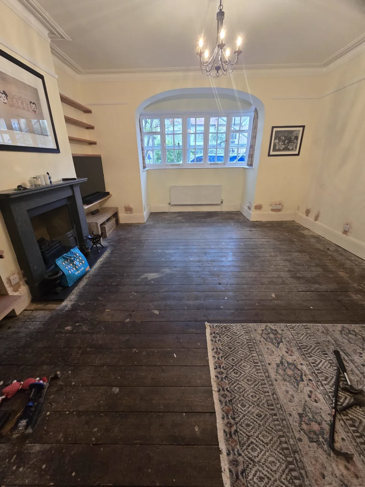 The real room before: tired near-black pine floorboards