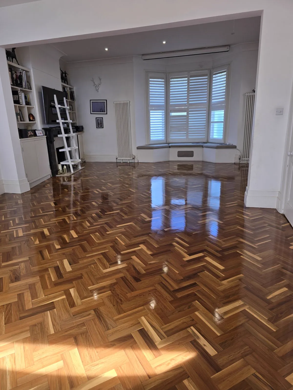 Restored herringbone parquet with high-gloss finish in Clapham SW4