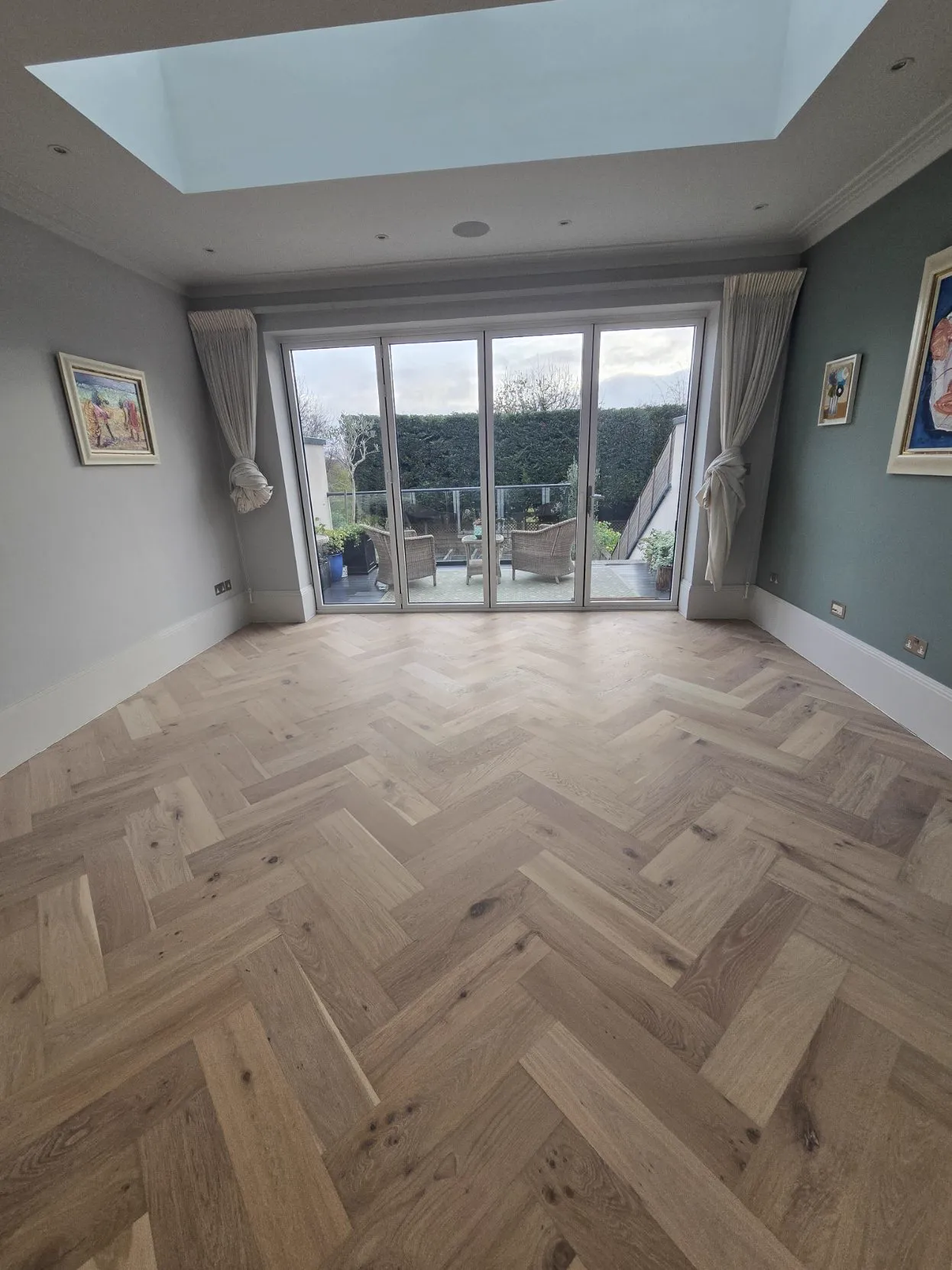 Raw-look pale oak herringbone parquet floor in a garden room, fitted and finished by Howard Naish