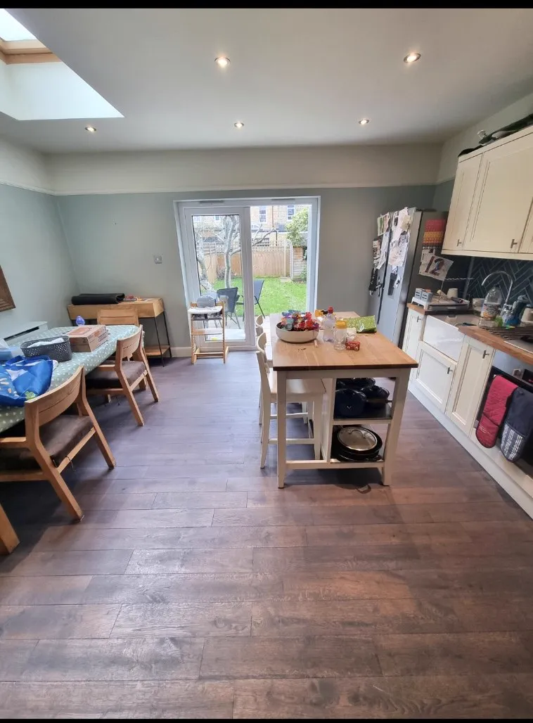Dark stained wide boards in a Sutton SM1 family kitchen-diner